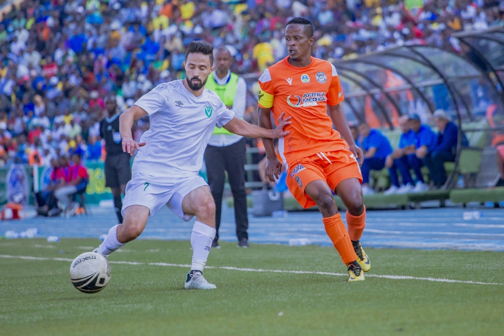 A player of Libyan side, Al Nasr holds off AS Kigali skipper Haruna Niyonzima during the CAF Confederation first leg tie which ended in a goalless draw on Saturday at Huye stadium. / Courtesy