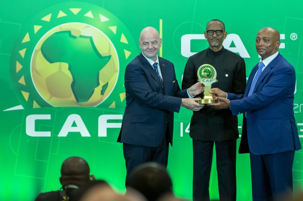 President Paul Kagame receives the CAF President’s Outstanding Achievement Award 2022 from the President of the Confederation of African Football (CAF), Patrice Mostepe and FIFA President Gianni Infantino in Kigali. Photo by Olivier Mugwiza