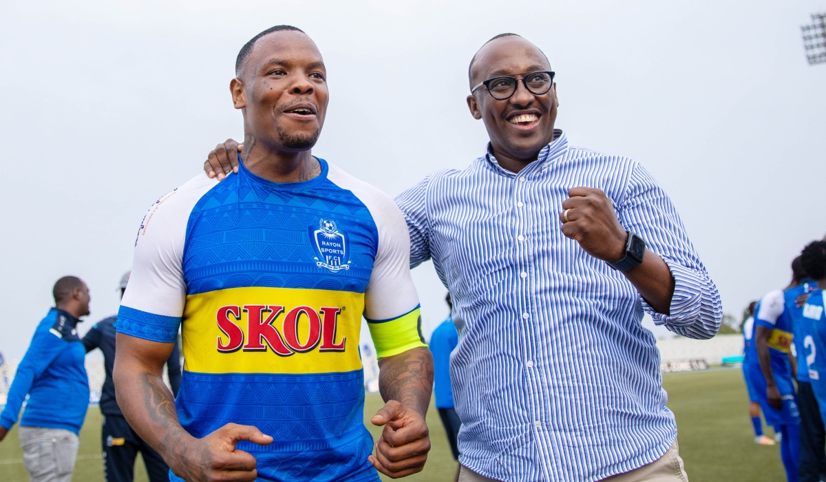 Rayon Sports skipper Abdoul Rwatubyaye with a team supporter celebrate the 1-0 victory over APR FC at Huye stadium. The captain has said that the club have not given up on league title hopes. Olivier Mugwiza