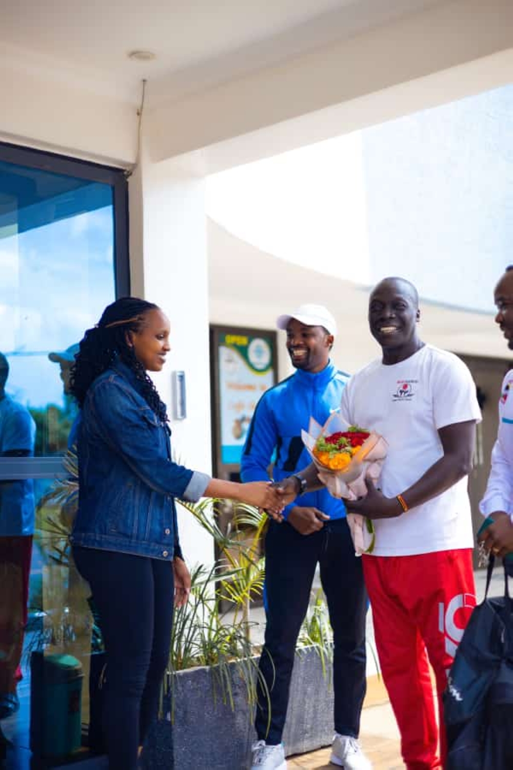 Christine Ingabire, one of the female karate practitioners in Kigali, shares a light moment with James Opiyo after welcoming him to Rwanda on Friday, April 28.