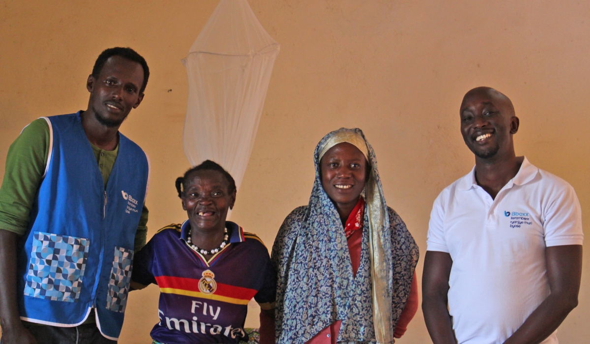 BBOXX Marketing and Communications Manager Babu Emile celebrates with residents in Rutsiro after electricity was installed in their home