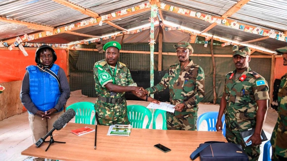 Atmis Burundi National Defence Forces Commander of the Forward Operating Base (FOB) Lt Col Richard Binyenimana (L) shakes hands with Somalia National Army Commander Maj Gen Bashir Abukar Ahmed during the handing over Xaaji Cali FOB in Hirshabelle State in Somalia on June 20, 2023. PHOTO | ATMIS