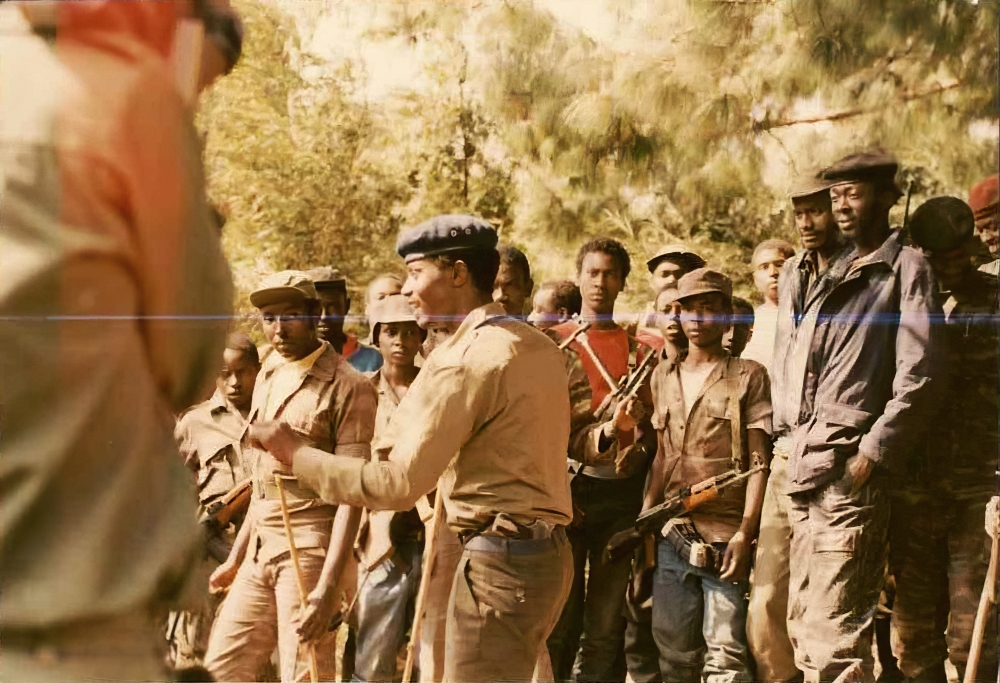 Late Commander Mico (with pistol), then commander of Charlie Mobile Force speaking to fighters at Mountain Sabyinyo in 1991.