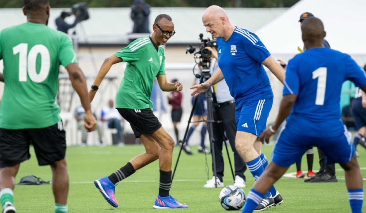 FIFA president Gianni Infantino controls the ball as he tries to go past President Paul Kagame during the match at the inauguration of Kigali Pele Stadium on March 15. Photo by Village Urugwiro