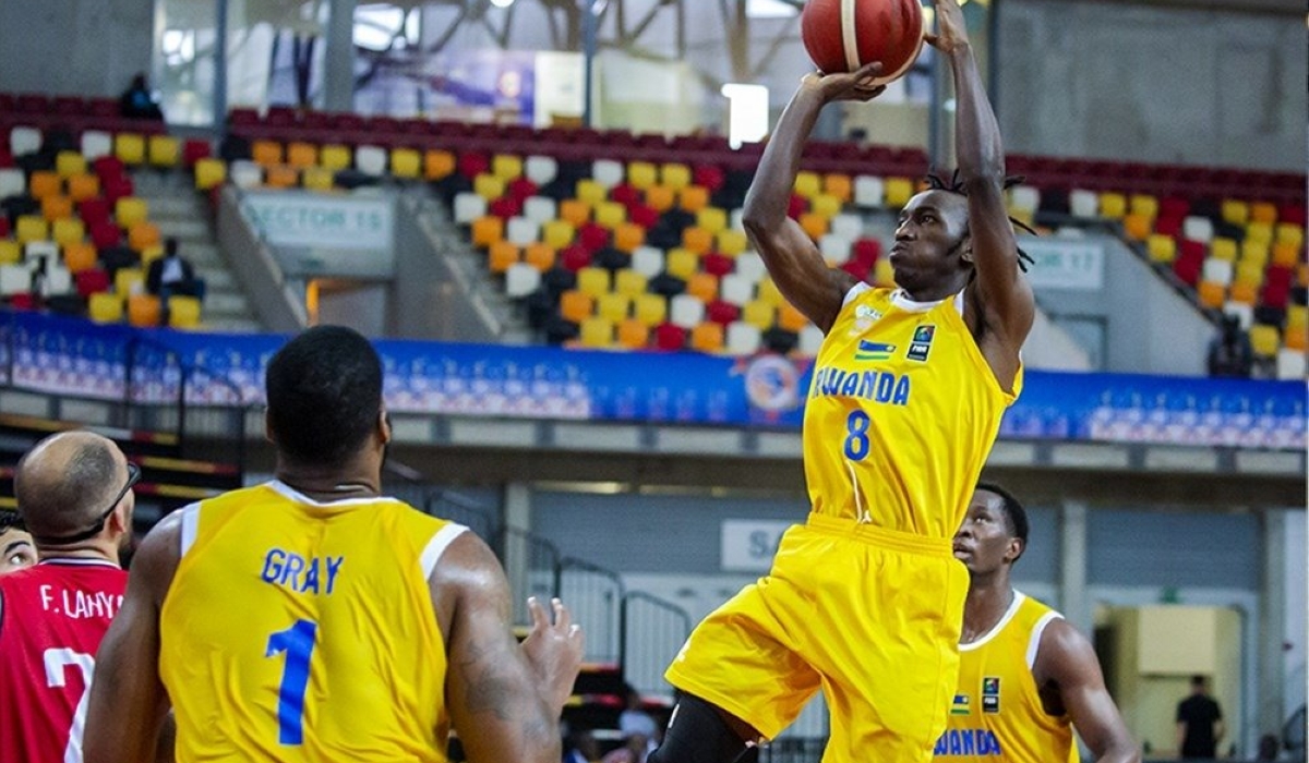 Rwanda&#039;s Nshobozwabyosenumukiza with the ball against Tunisia.  Rwanda lost the game with 61-67 in Saturday’s Group C opening game held at Arena Kilamba in Luanda. Photos by  FIBA