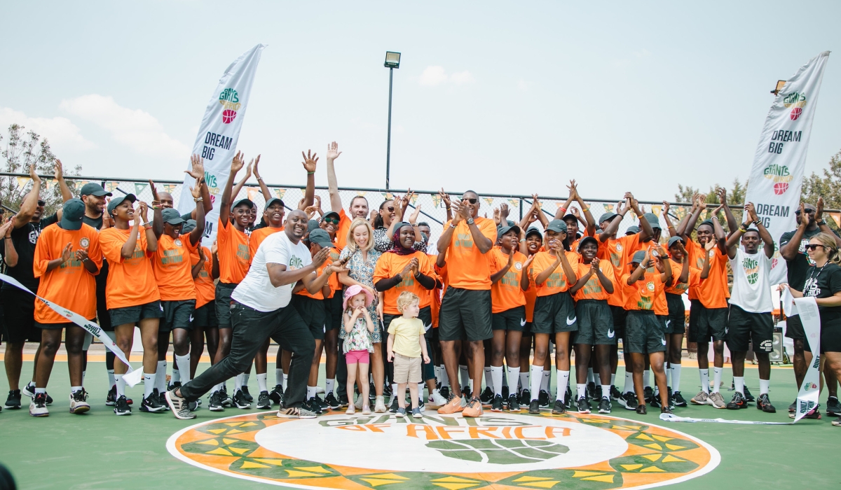 Delegates and students pose for a photo during the official launch of two new outdoor basketball courts  Sunday, August 13 in Rwamagana District, Eastern Province. ALL PHOTOS BY WILLY MUCYO