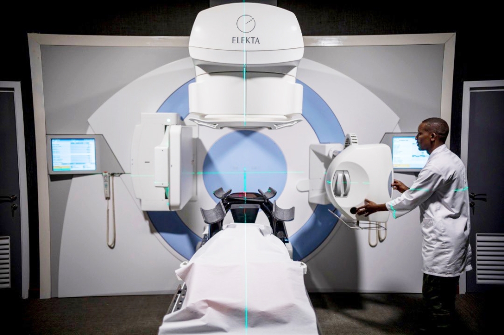 A medic shows how the newly installed machine functions inside the Radiotherapy cancer centre at Rwanda Military Hospital, in Kanombe. Courtesy