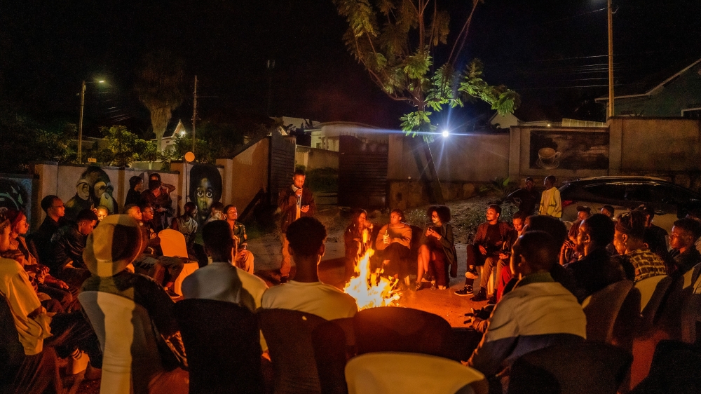 Participants during an open mic session around a fire pit on March 30 at Sundays Art Hub.