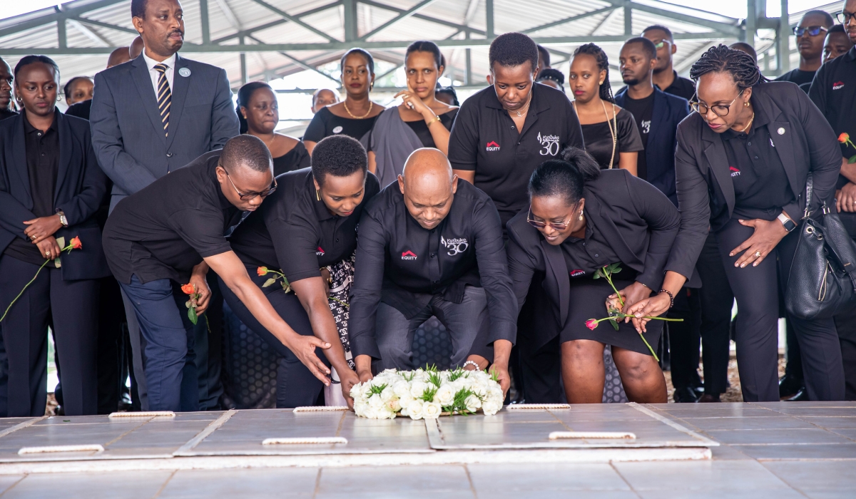 Hannington Namara, Managing Director of Equity Bank Rwanda (c) with other bank officials lay a wreath to pay tribute to victims of the Genocide against the Tutsi on April 30. Dan Gatsinzi