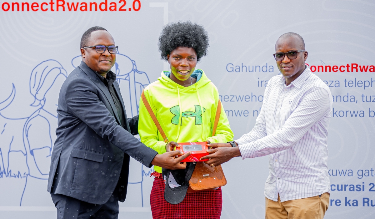 Paulian Kazibwe, the Airtel Rwanda Finance Director(L) hands over a smartphone to one of residents in Rusizi District on Friday, May 10. &#039;ConnectRwanda 2.0&#039;  aims to bring digital connectivity to every corner of Rwanda. Courtesy