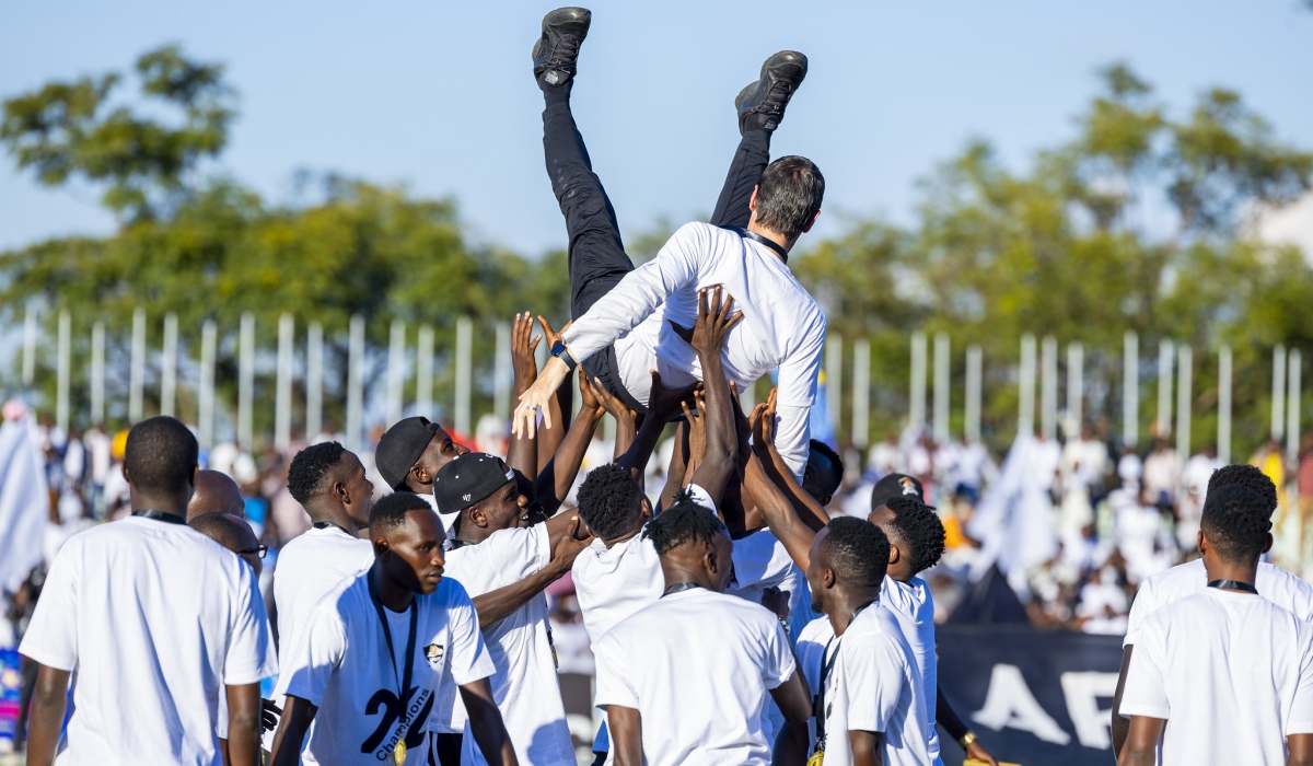 APR FC  head coach Thierry Froger is lifted by his players while celebrating the 22nd national league title on Sunday May 12. Olivier Mugwiza