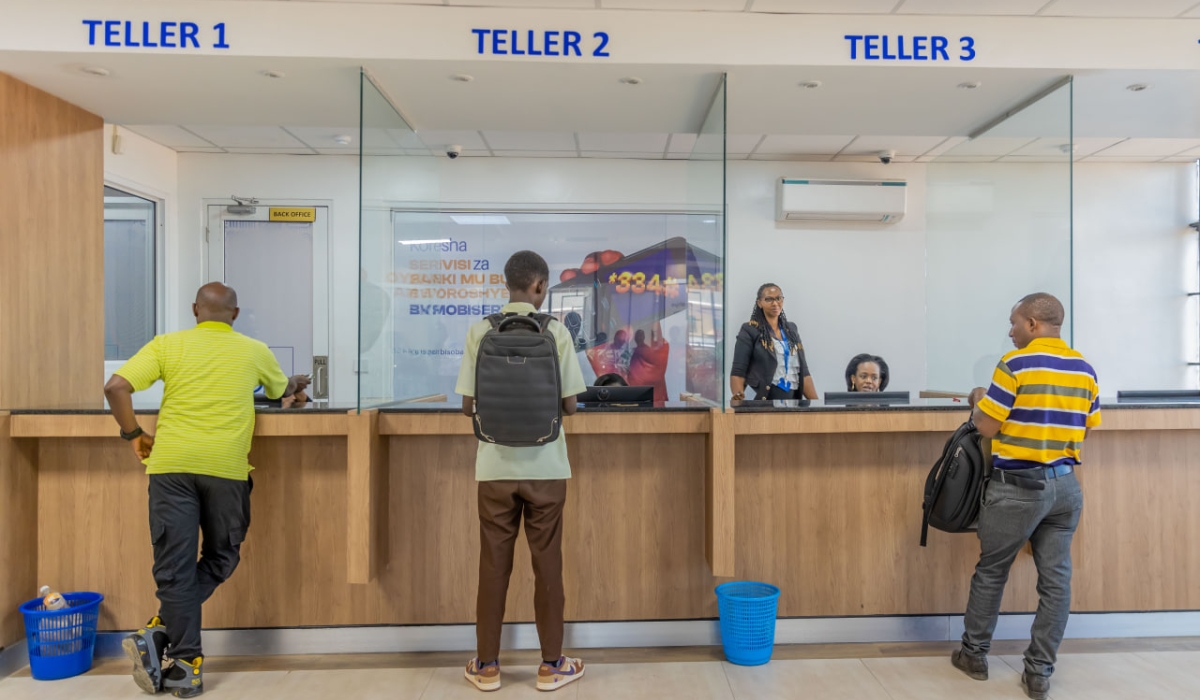 Bank of Kigali tellers attend to clients at Giporoso branch in Remera.Courtesy