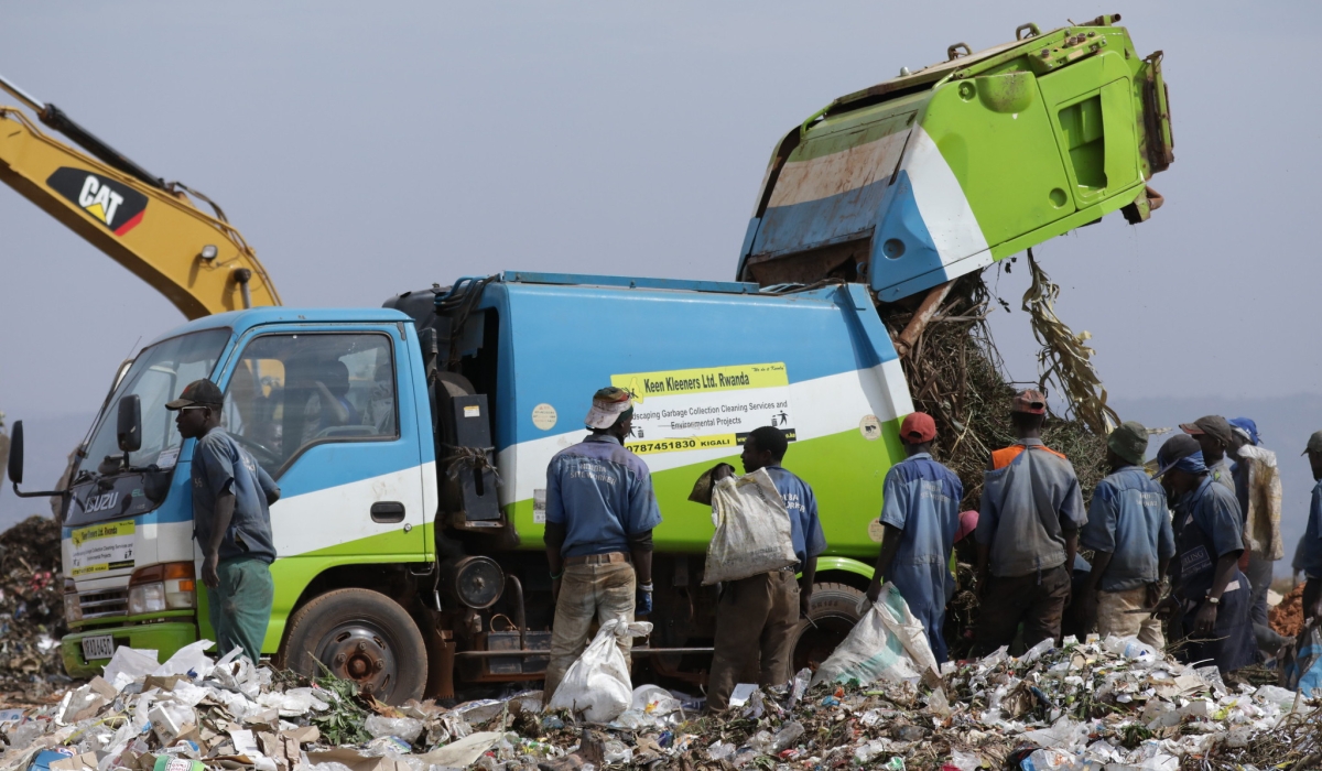 Garbage collectors sorting waste at Nduba landfill in Gasabo District