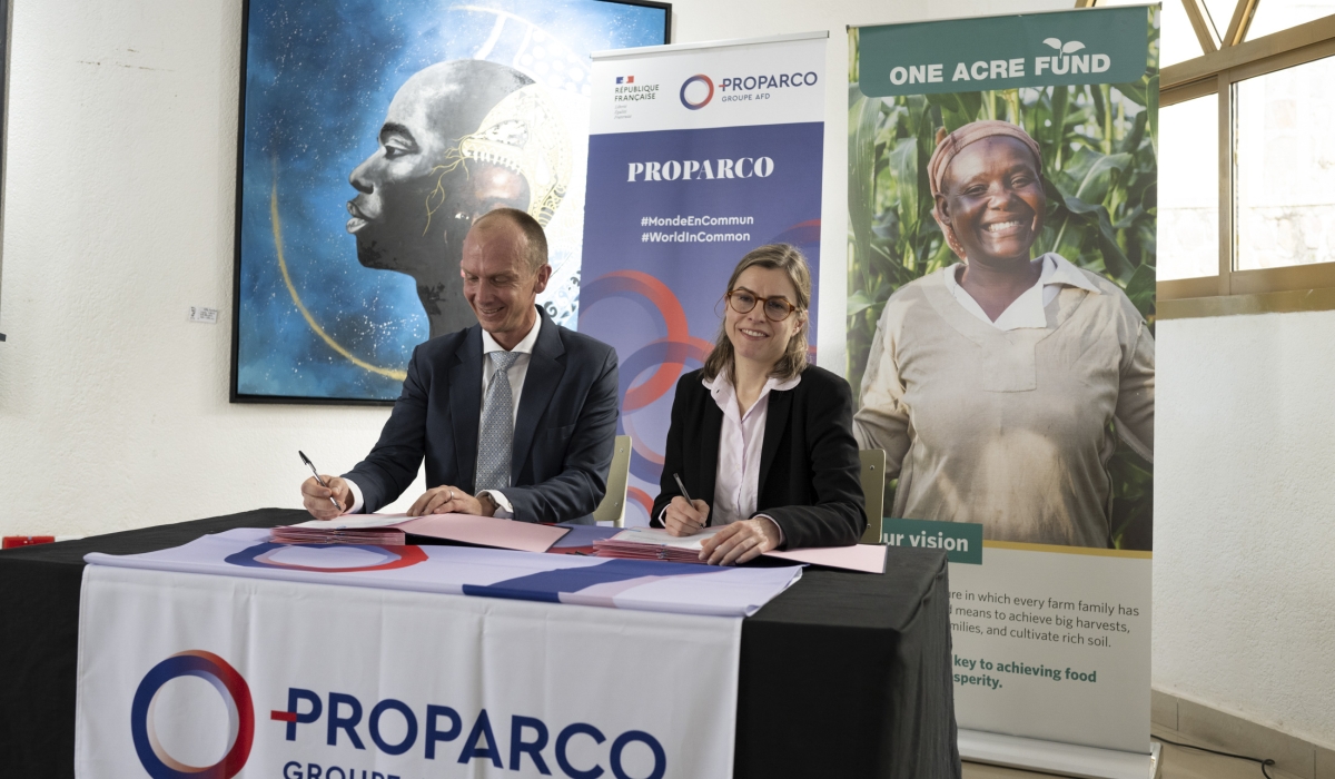 Françoise Lombard, the CEO of Proparco and  One Acre Fund’s CEO, Eric Pohlman sign the agreement in Kigali on Wednesday, May 15. Courtesy