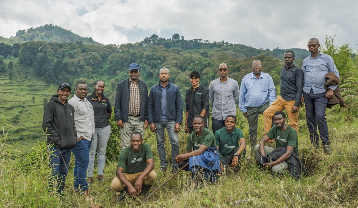 Delegates pose for a group photo as the African Wildlife Foundation (AWF) officially handed over the restored land to the Rwanda Development Board (RDB) for inclusion in the Volcanoes National Park On May 18.