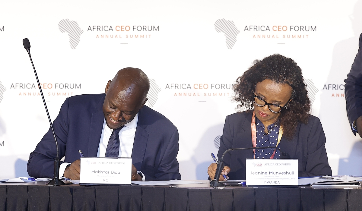 Jeanine Munyeshuli, the Minister of State for Public Investments and Resource Mobilization, and Makhtar Diop, the Managing Director of the International Finance Corporation, signing an agreement in Kigali on May 16. Courtesy