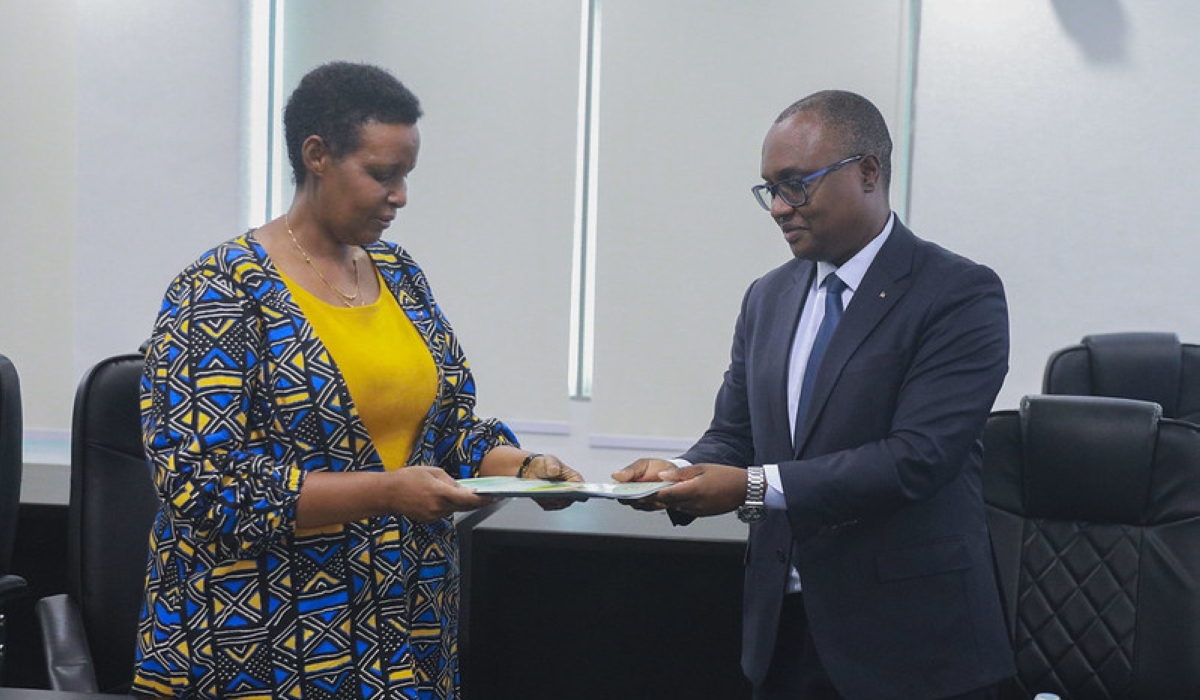 Social Democratic Party (PSD) Secretary-General Jean-Chrysostome Ngabitsinze submits the list of his party’s candidates to NEC Chairperson Oda Gasinzigwa, on Monday, May 20. Craish Bahizi