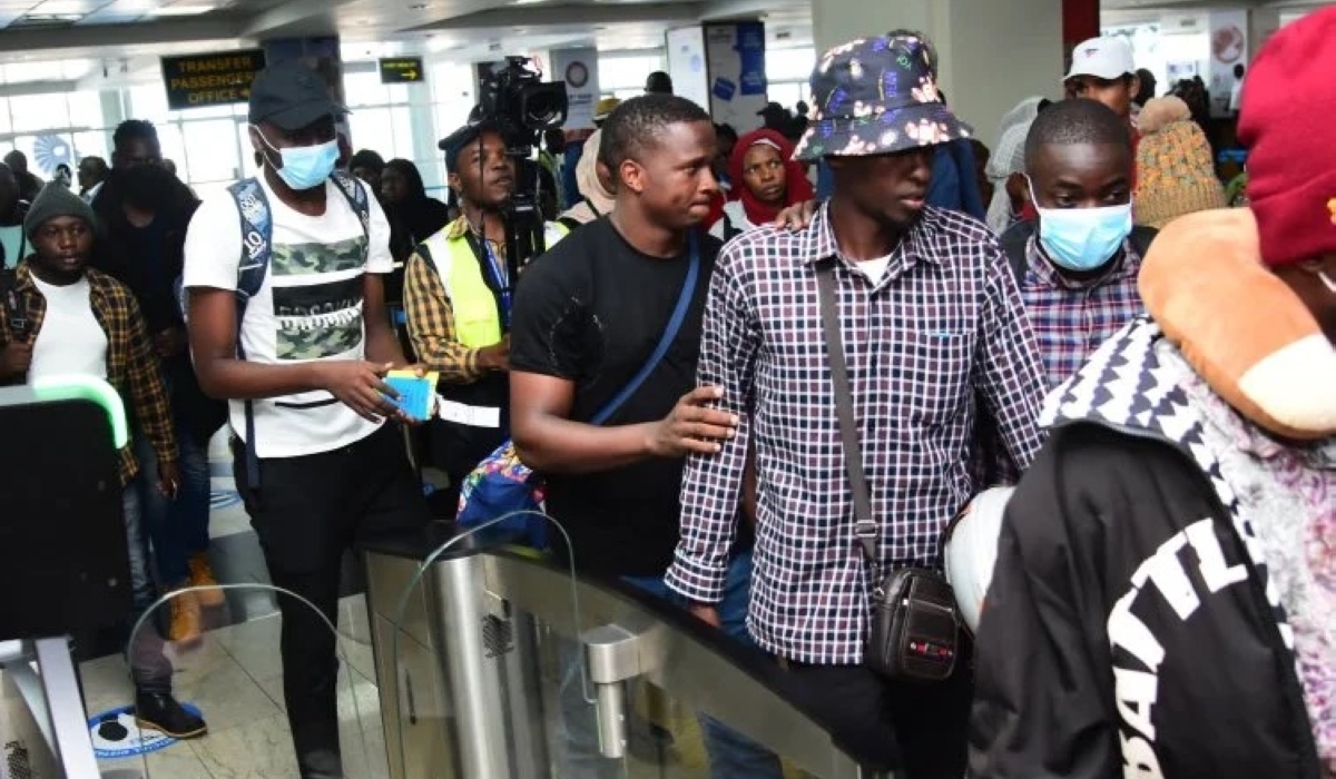 Some of the repatriated 23 Ugandan citizens who were victims of human trafficking in Myanmar, soon after arriving at Entebbe International Airport on Thursday, May 23.