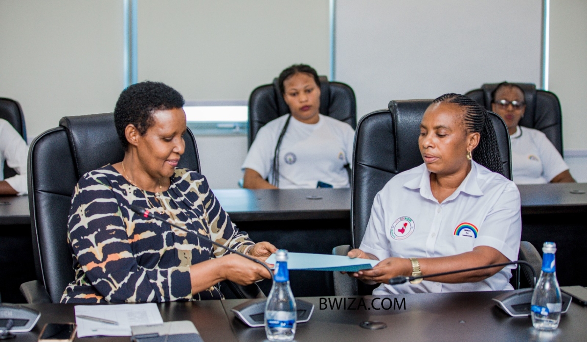 The Chairperson of PS Imberakuri, Christine Mukabunani, presents a list of 80 candidates for the parliamentary polls to the Chairperson of the National Electoral Commission, Oda Gasinzigwa.