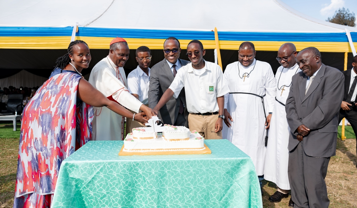 Cardinal Antoine Kambanda and Minister of Education Gaspard Twagirayezu join students to cut a cake during Lycee de Kigali&#039;s celebration of golden jubilee  on Saturday, June 8. Photos by Christianne Murengerantwari