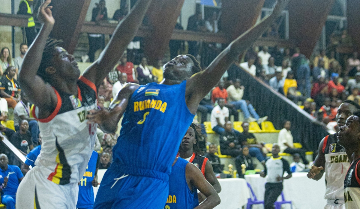 A Ugandan players tries to block his Rwandan opponent from shooting the ball as the hosts beat Rwanda 78-49 to maintain their unbeaten run at the Afrobasket U18 qualifiers-courtesy