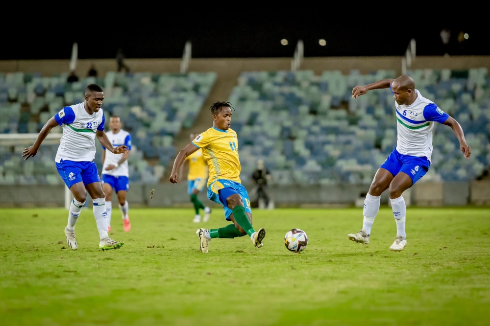 Midfielder Kevin Muhire wins the ball against Lesotho players 