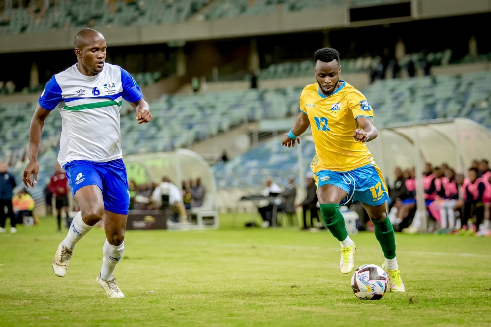 Amavubi&#039;s Gilbert Mugisha tries to go past Lesotho defender during the match in Durban