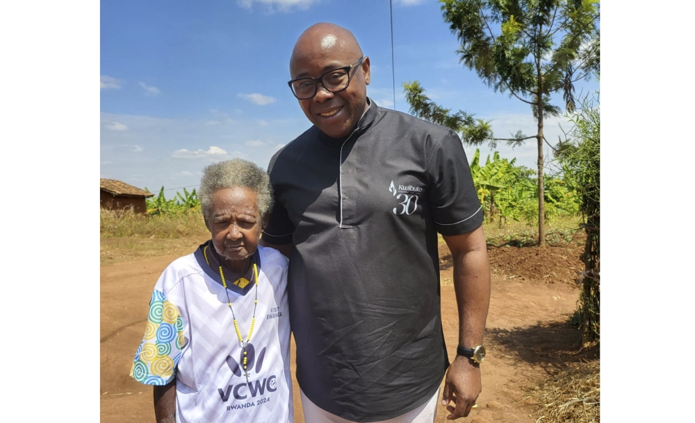 Fred Siewe, VCWC founder and Chairperson and Madeleine Mukanemeye,  Mama Mukura pose for a photo in Gisagara District. The national team fan has been named the official trophy bearer of the inaugural Veteran Clubs World Championship (VCWC) which will take place in Kigali from September 1-10. Photos by Alexis Kayinamura