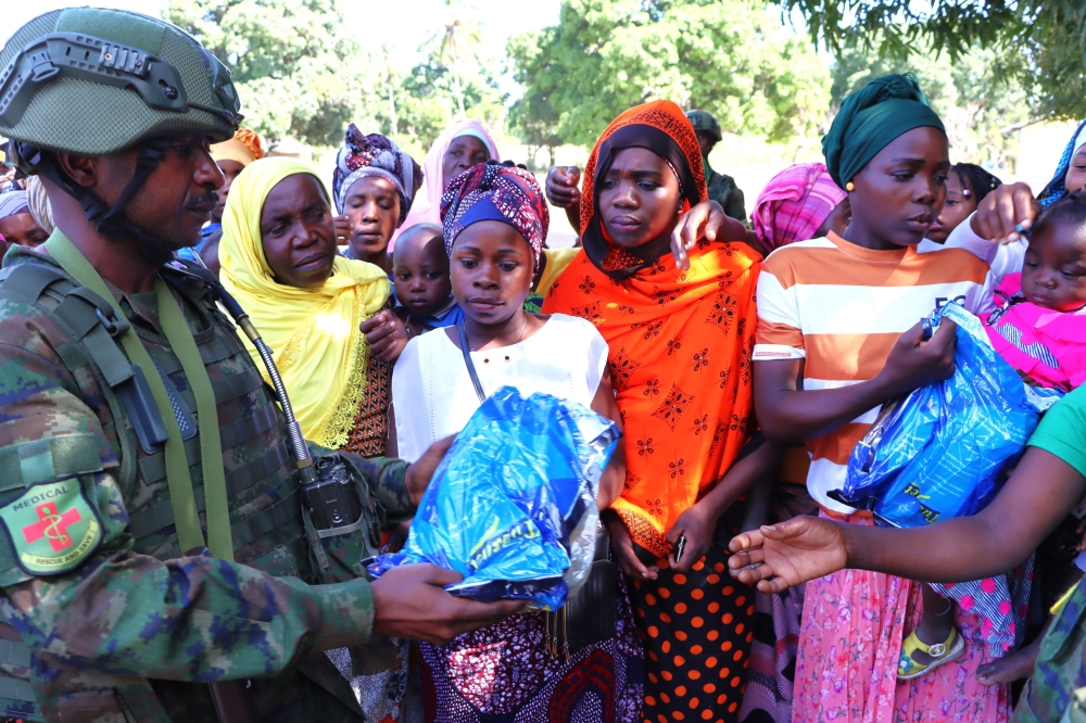 A Rwanda Security Force medical officer gives expecting mothers in Ntotwe village, in Mocimboa da Praia District, mosquito nets, on Tuesday, June 11. Courtesy