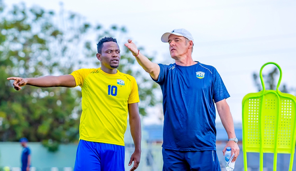 National football team (Amavubi) head coach Frank Spittler Torsten gives instructions to Muhadjili Hakizimana during a training session at Bugesera Stadium. File