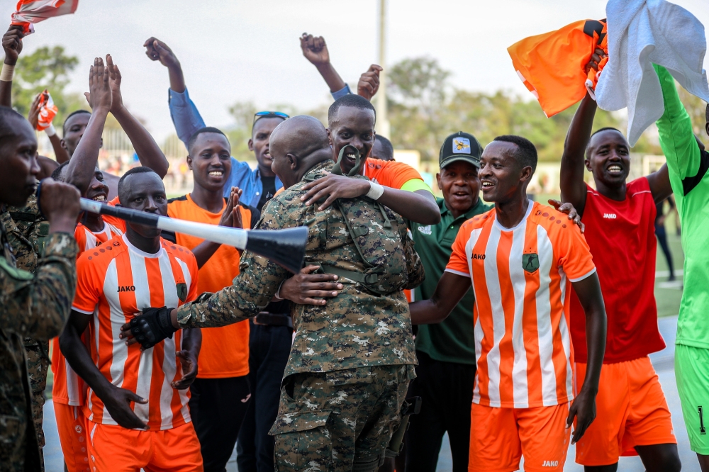 Captain Ian Kagame (c) and teammates celebrate with their supporters as the Republican Guard  team won the third straight RDF Liberation Cup tournament  after defeating BMTC Nasho 3-0 in the 2024 final match at Kigali Pele stadium on Sunday, June 16. Photos by Craish Bahizi