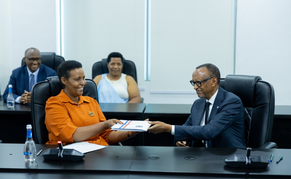 President Paul Kagame (R) presents his candidature to the Chairperson of the National Electoral Commission, Oda Gasinzigwa, on May 17, 2024, as he seeks re-election as the Head of State. Photo by Olivier Mugwiza