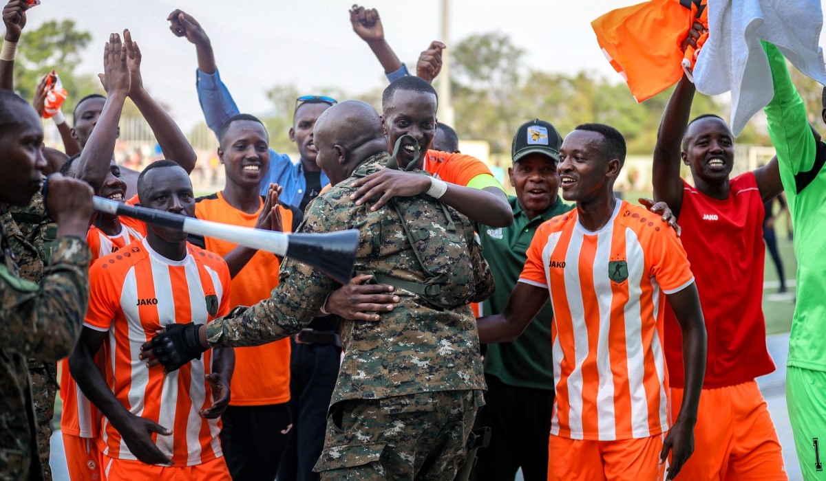 Captain Ian Kagame (c) and teammates celebrate with their supporters as the Republican Guard  team won the third straight RDF Liberation Cup tournament  after defeating BMTC Nasho 3-0 in the 2024 final match at Kigali Pele stadium on Sunday, June 16. Photos by Craish Bahizi