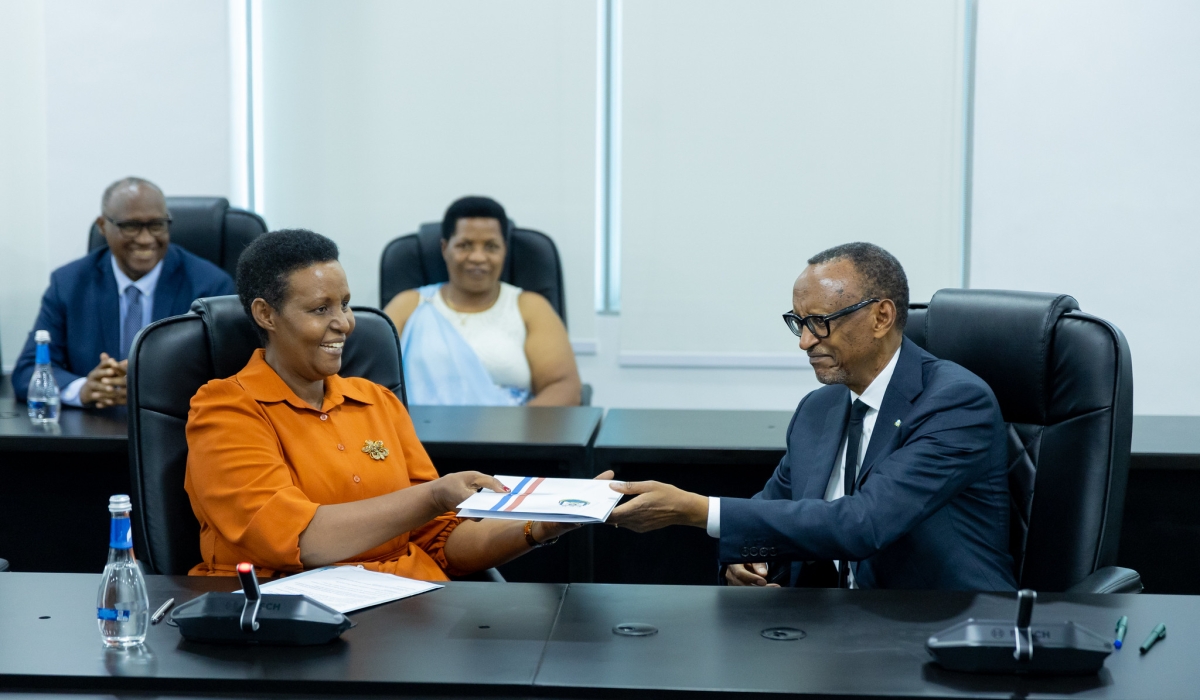 President Paul Kagame (R) presents his candidature to the Chairperson of the National Electoral Commission, Oda Gasinzigwa, on May 17, 2024, as he seeks re-election as the Head of State. Photo by Olivier Mugwiza