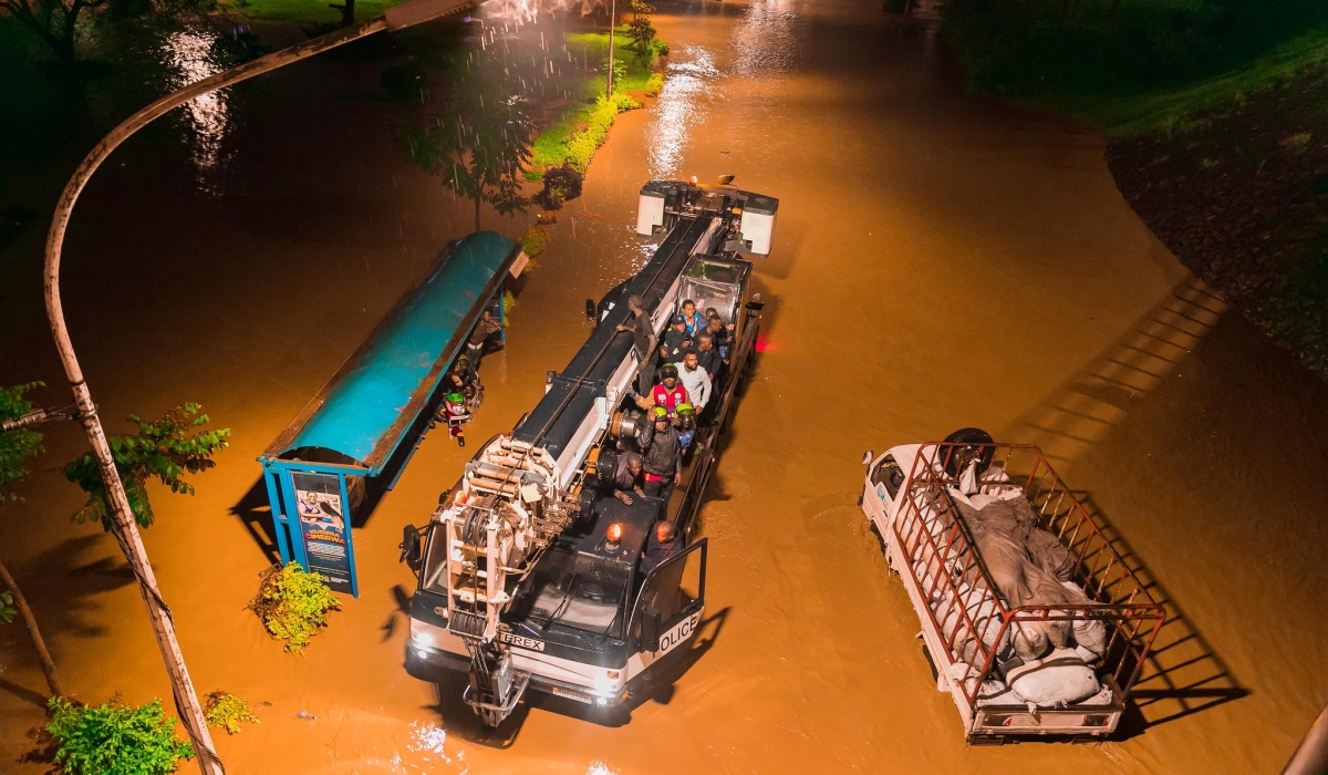 Rwanda National Police officers rescue Kigali residents who got stranded at a flooded street  on February 3, 2020. File