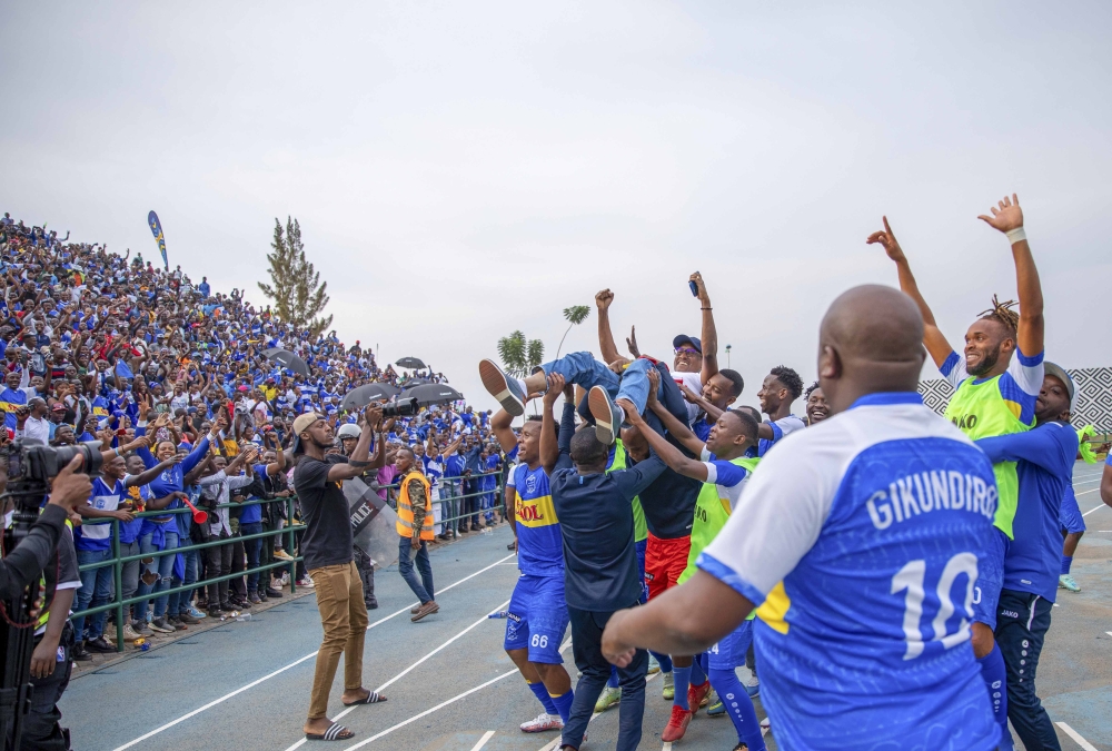 Rayon Sports players lift up the team President Jean Fidele Uwayezu  to celebrate the crucial win over APR FC at Huye stadium  on February 12, 2023. Photo by Olivier Mugwiza