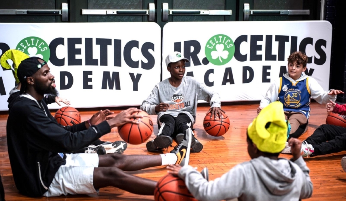 Rwandan international basketball coach Ali Rugira gives instructions to young children during a coaching course. Courtesy