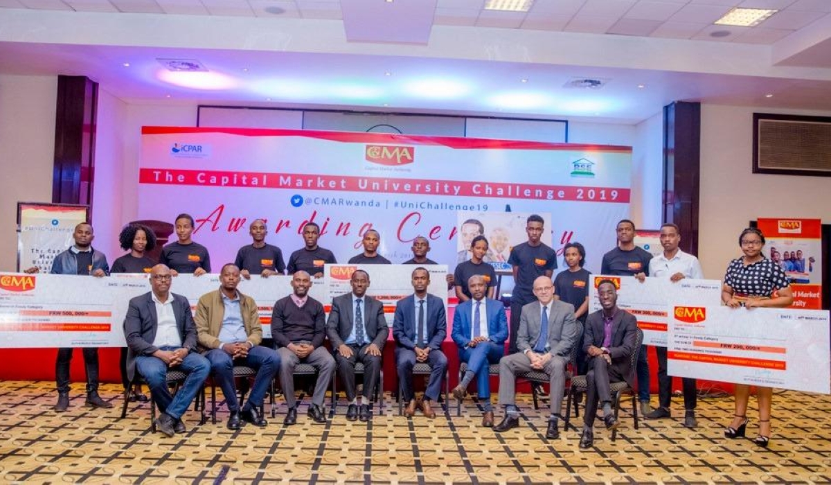 Officials pose for a group photo with the winners of the previous competition. Winners of the 11th edition of Capital Market University Challenge will be announced during the ceremony slated for Friday, June 21.