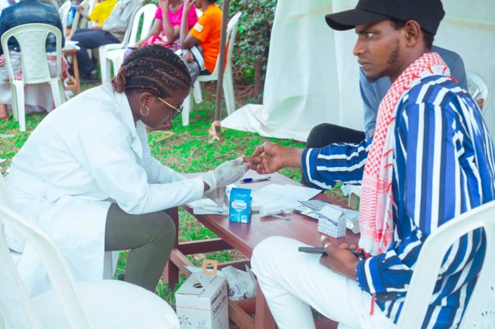 A nursing graduate, among the youth on a mission to educate and raise awareness on HIV, tests a Rwamagana resident