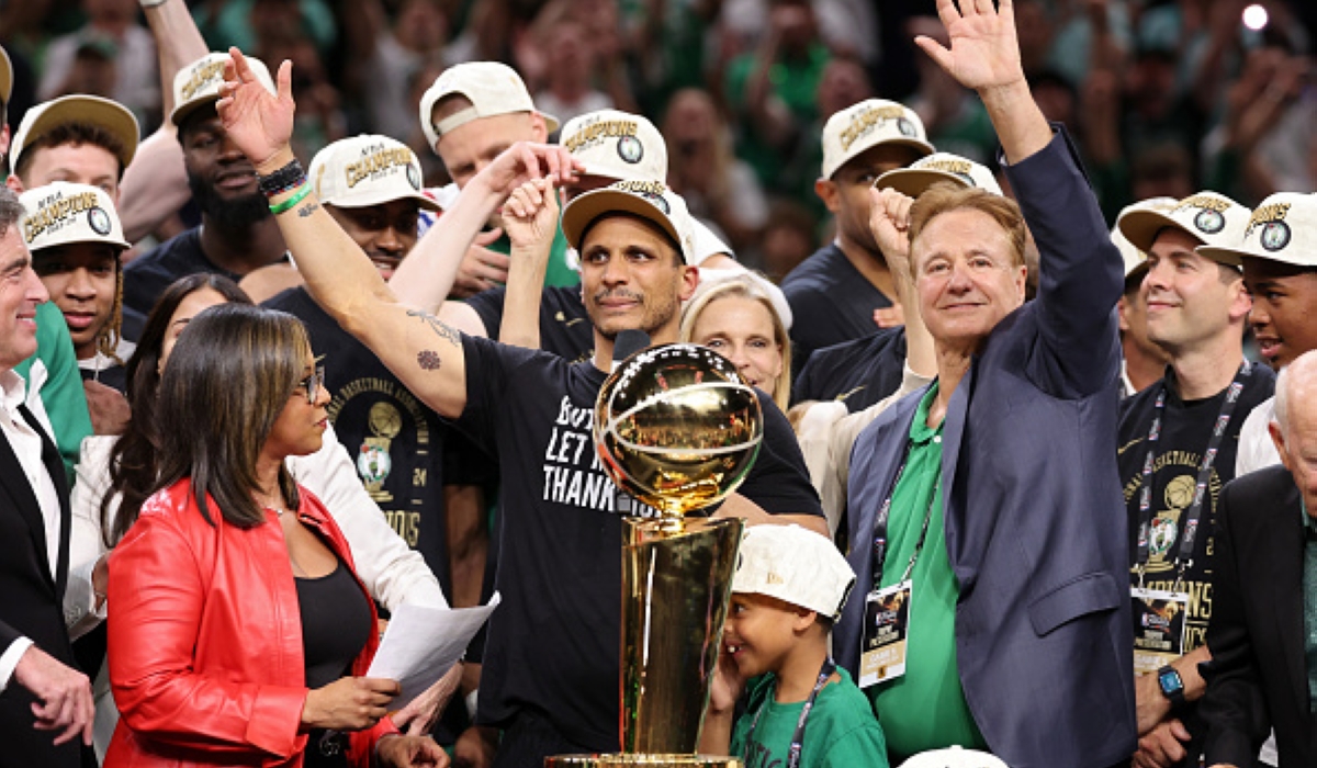 Celtics&#039; coach Joe Mazulla (C) celebrates with the trophy.