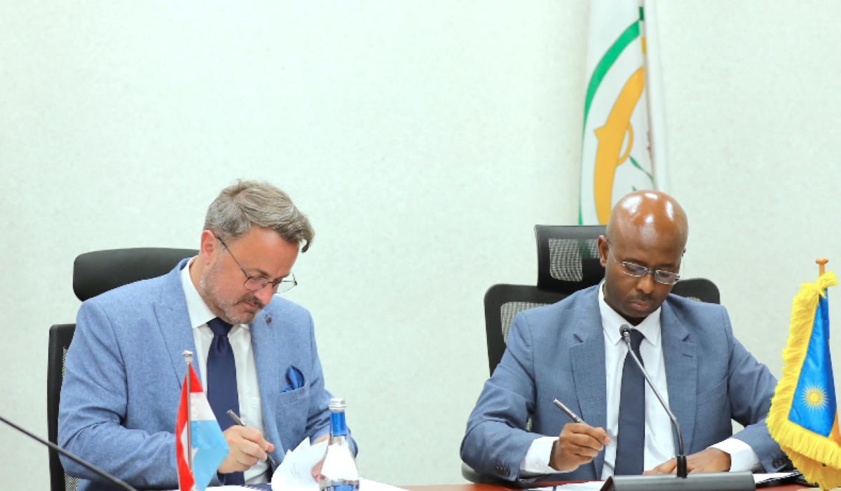 Luxembourg’s Prime Minister and Minister of Foreign Affairs, Xavier Bettel and Finance Minister Yusuf Murangwa sign the agreement in Kigali on June 18. Courtesy