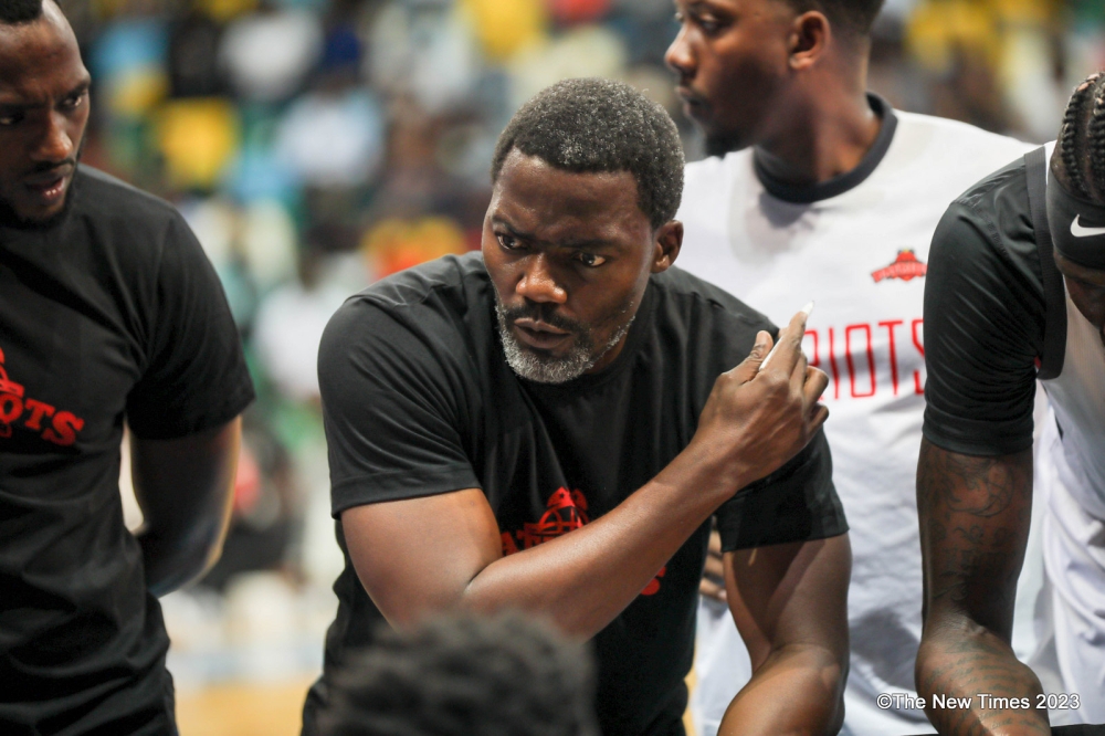 Patriots basketball club head coach Henry Mwinuka gives instructions to the players during a league game against APR BBC. Dan Gatsinzi