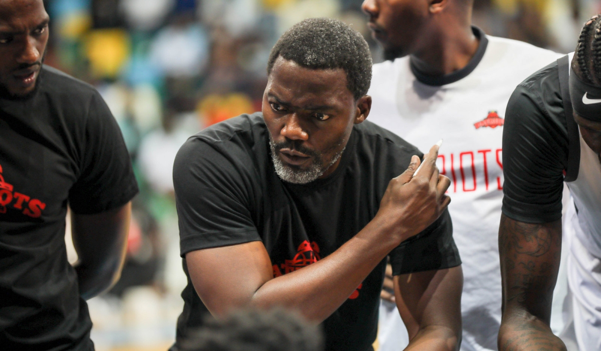 Patriots basketball club head coach Henry Mwinuka gives instructions to the players during a league game against APR BBC. Dan Gatsinzi