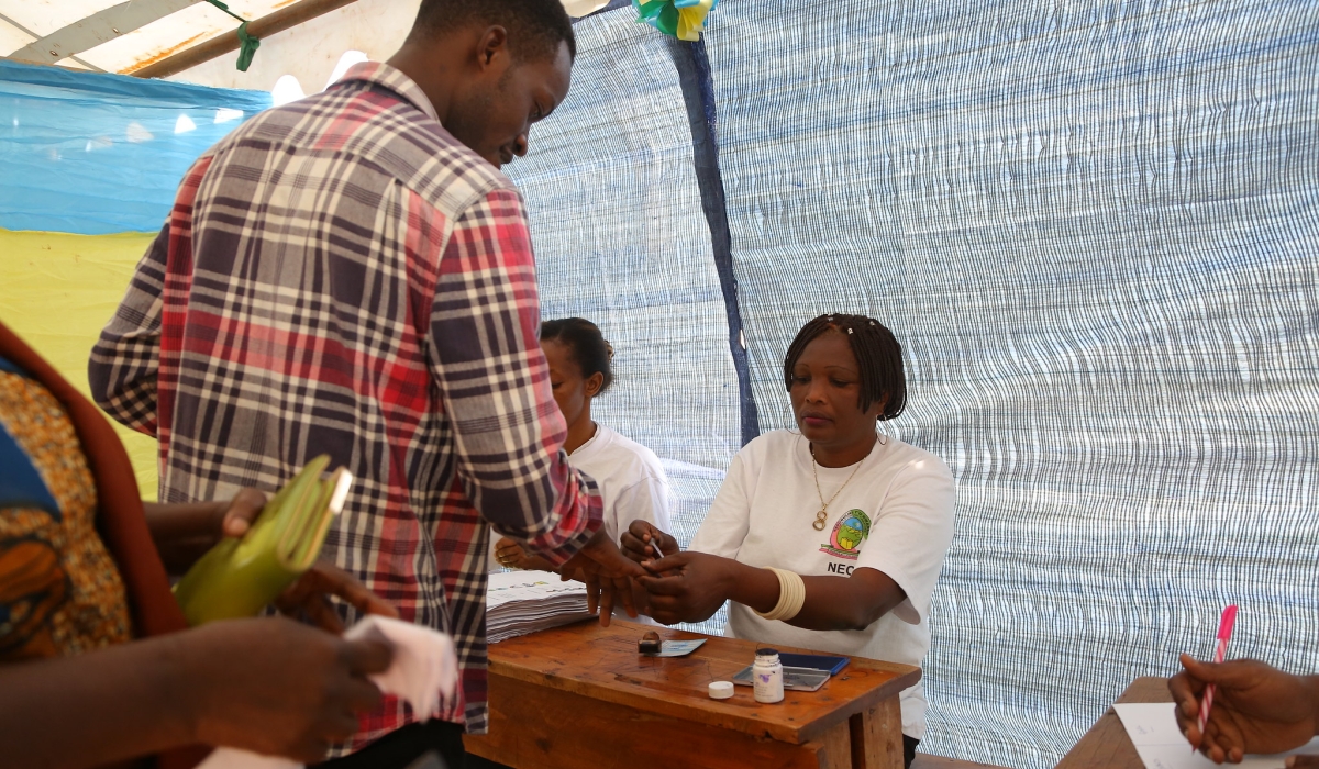 Electoral commission volunteers help voters during the parliamentary elections in at Zindiro site in Gasabo on September 3, 2018. Sam Ngendahimana