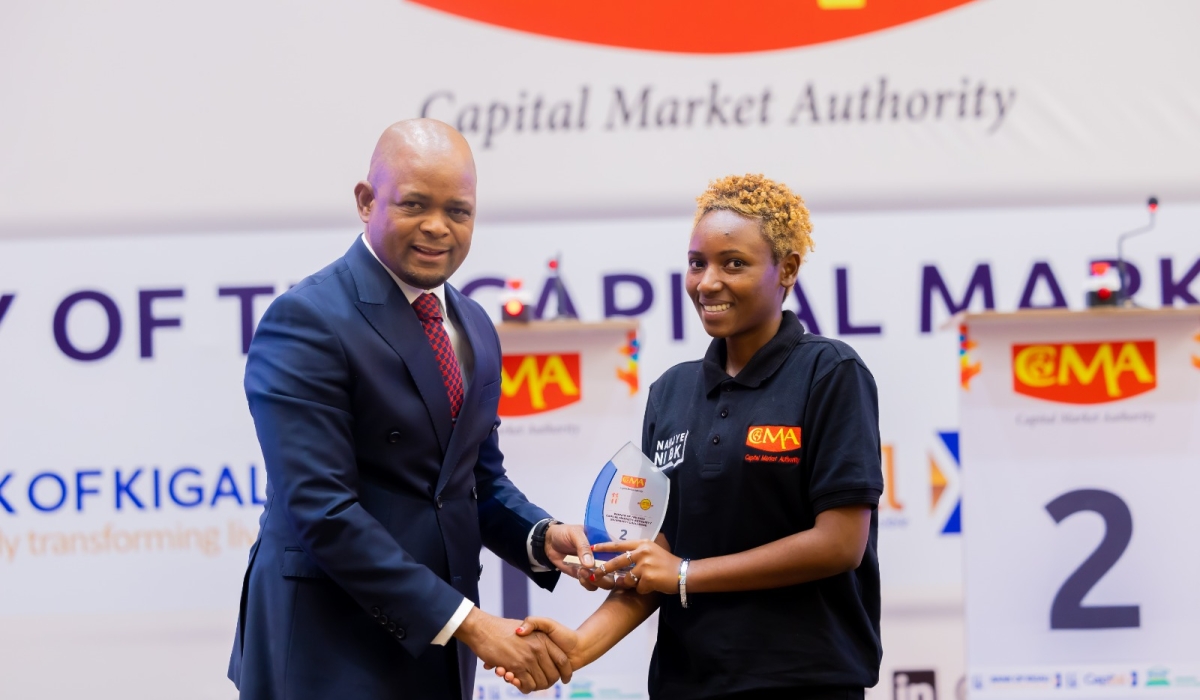 Thapelo Tsheole, chief executive of CMA, presents a trophy to Esther Ashimwe, the first runner-up in the 2024 Capital Market University Challenge at the national level.