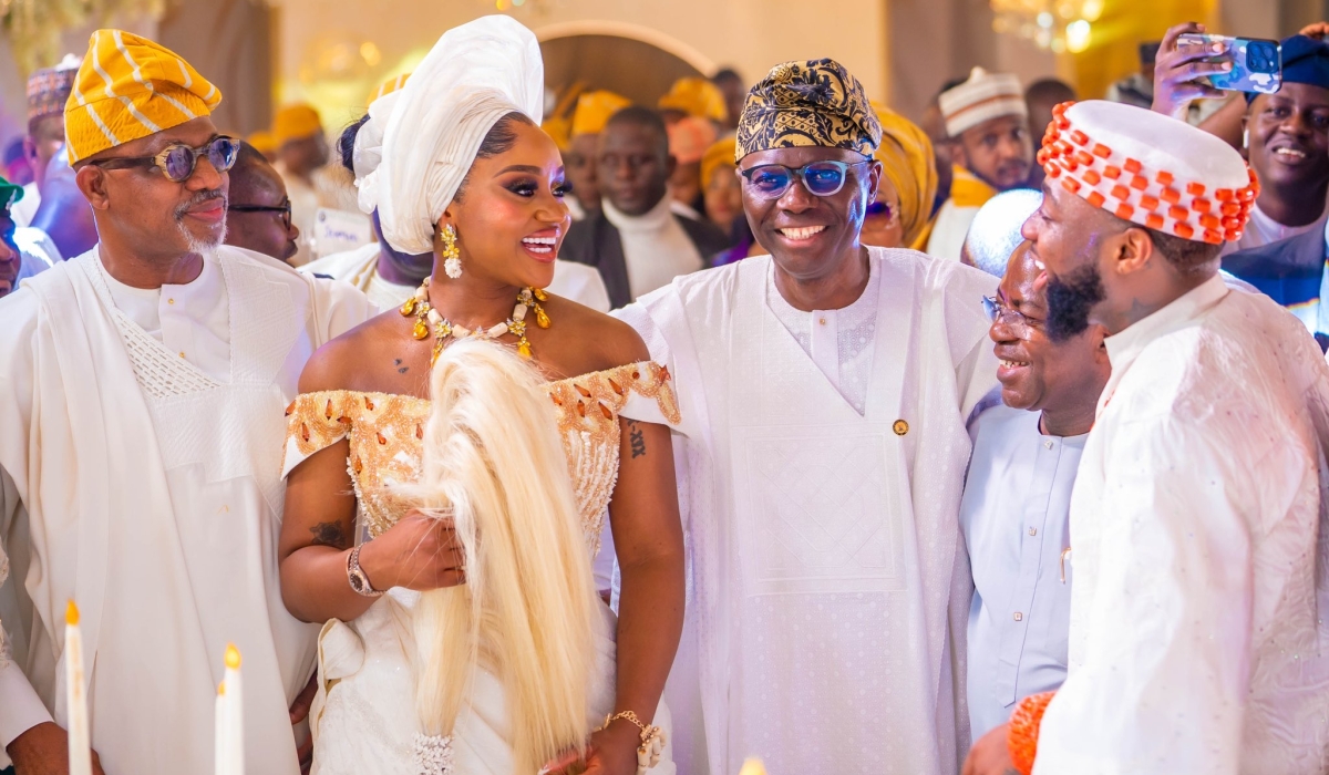 Nigerian musician Davio (R) and wife Chioma Rowland (2nd L) looking excited during their colourful wedding on Tuesday, June 25-courtesy