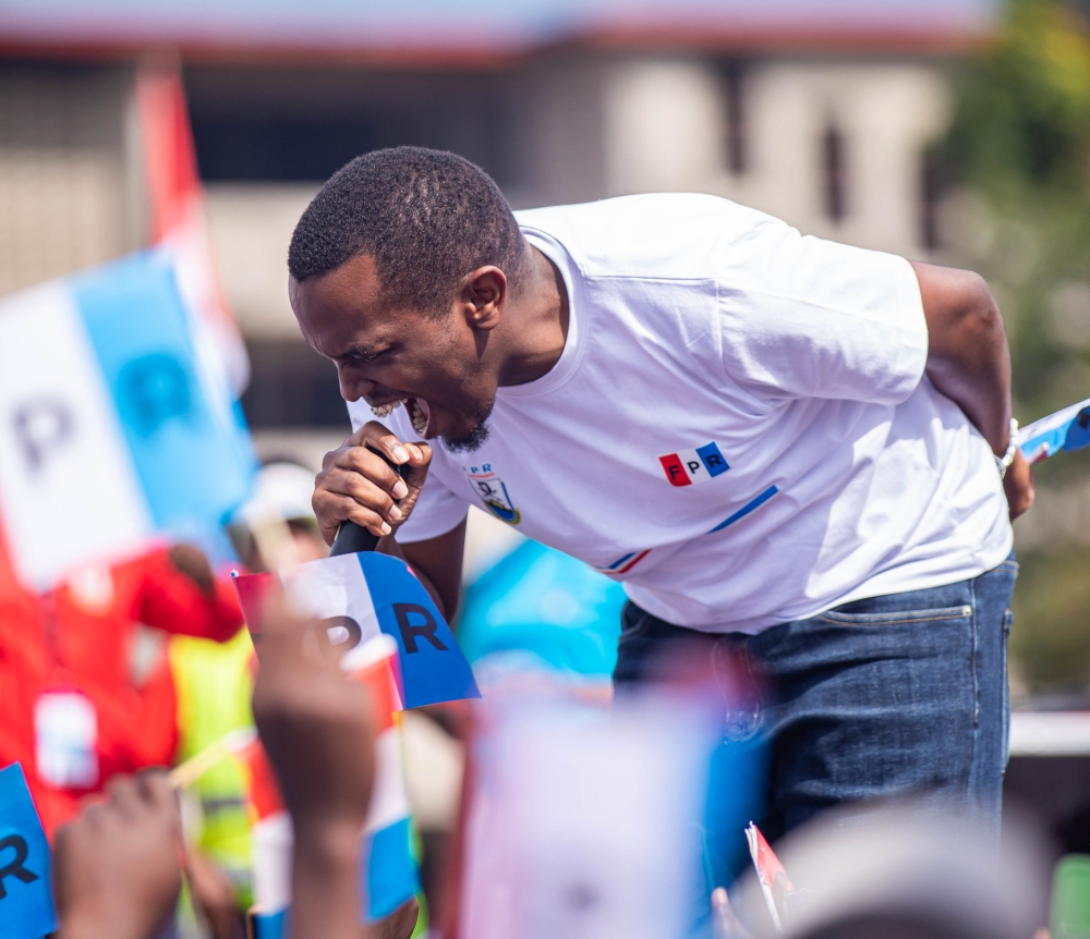 Artiste Tom Close during his performance in Musanze as RPF members campained at Stade Ubworoherane in Musanze. The campaign trail  attracted thousands of party supporters dressed in blue, black, and red t-shirts, baseball caps, and waving flags. Photos by Dan Gatsinzi