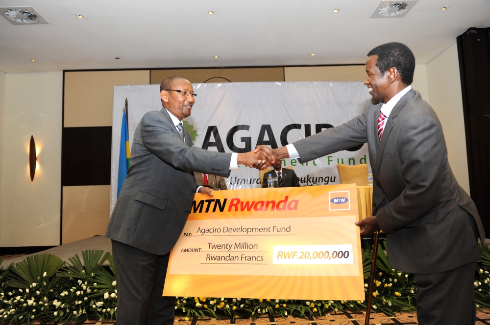 Minister John Rwangombwa recieves MTN Rwanda&#039;s contribution during the launch of Agaciro Development Fund on August 23, 2012. File