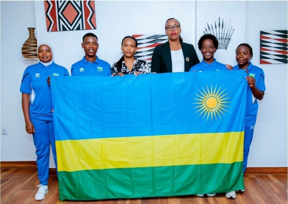 Rwandan cyclist Eric Manizabayo (2nd L) with other athlets who will represent Rwanda at the 2024 Olympic Games scheduled for July 26 to August 11 in Paris, France, receive a national flag before heading to France.