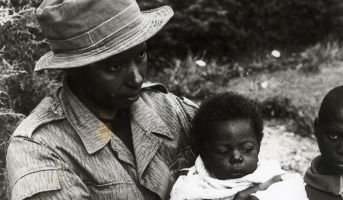 An RPA (now RDF) soldier holding a rescued baby right after the Genocide Against the Tutsi | Rwanda 1994